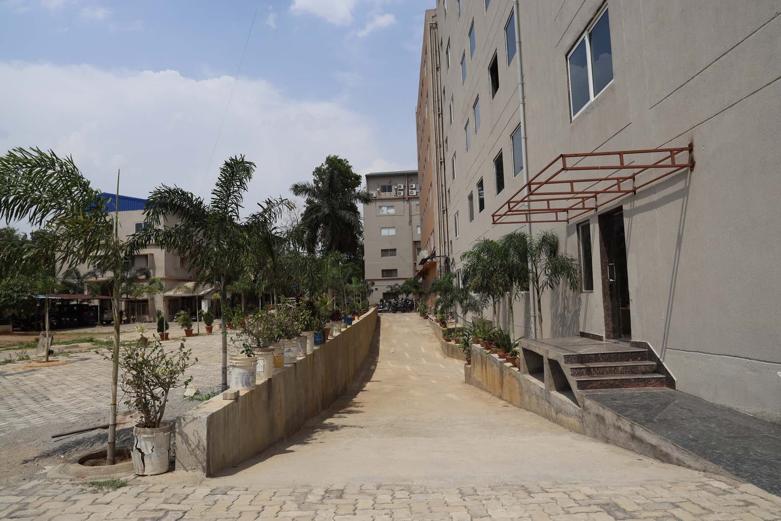 Landscaped campus walkway between buildings