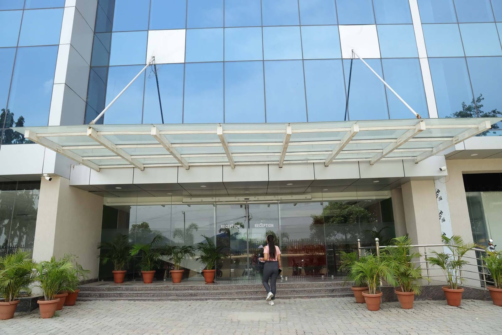 Glass canopy entrance with greenery