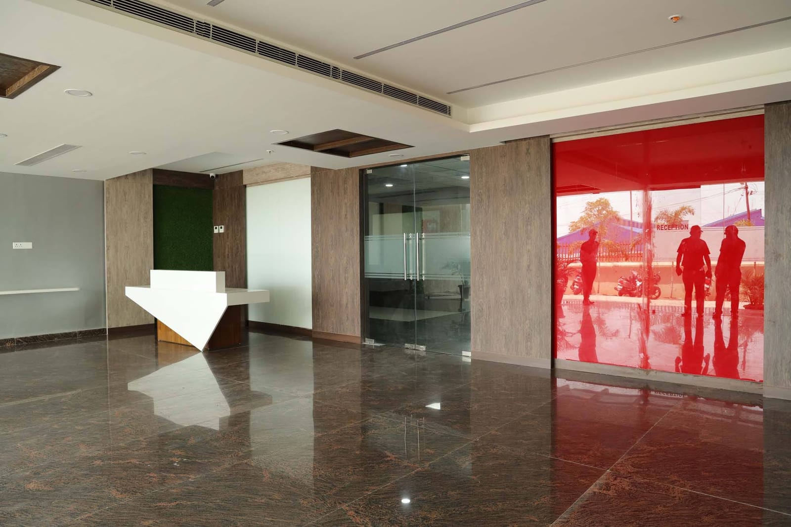 Reception lobby with red accent wall and polished floors